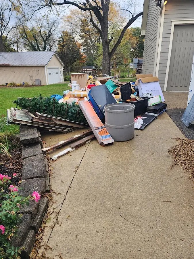 Dumpster being loaded with debris for 10 Yard Dumpster Rental in Lindale